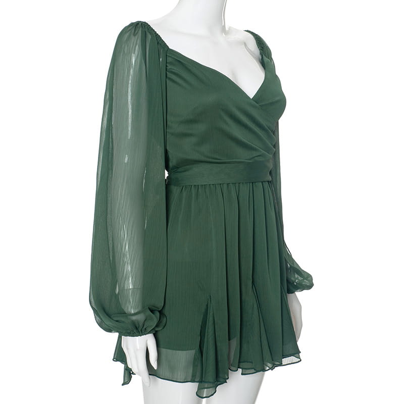 A dark green ruched chiffon long sleeve mini dress featuring a flowing design with a draped bodice and sheer long sleeves.