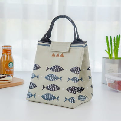 Mini cartoon oxford insulated picnic handbag in yellow with navy fish and white wave pattern featuring black handles.
