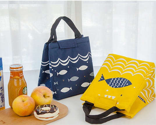 Mini cartoon oxford insulated picnic handbag in yellow with navy fish and white wave pattern featuring black handles.