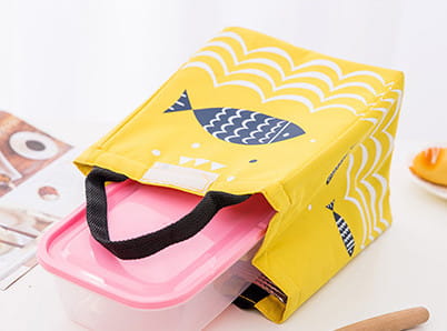Mini cartoon oxford insulated picnic handbag in yellow with navy fish and white wave pattern featuring black handles.