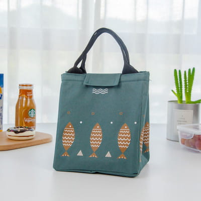 Mini cartoon oxford insulated picnic handbag in yellow with navy fish and white wave pattern featuring black handles.