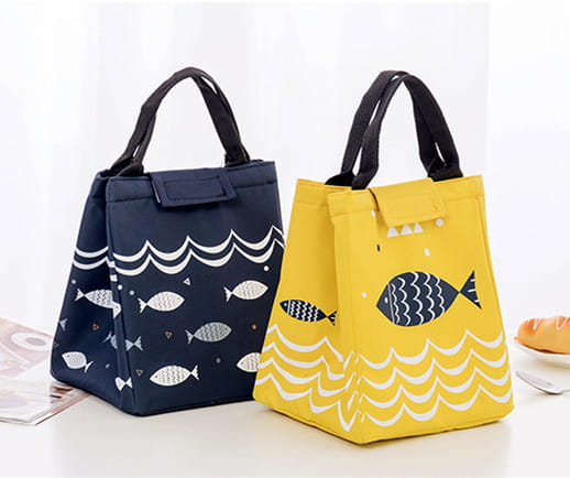 Mini cartoon oxford insulated picnic handbag in yellow with navy fish and white wave pattern featuring black handles.