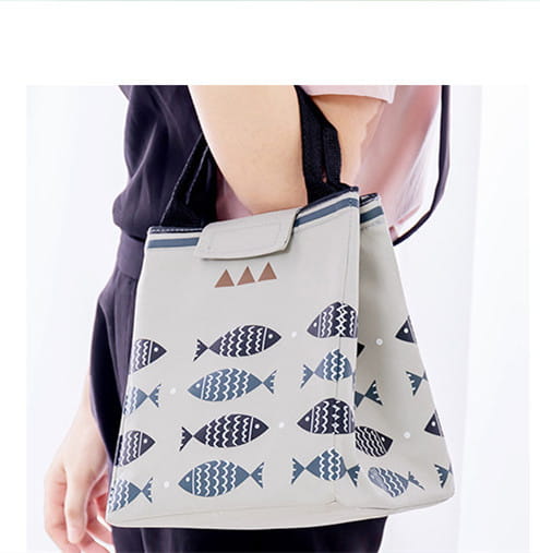 Mini cartoon oxford insulated picnic handbag in yellow with navy fish and white wave pattern featuring black handles.