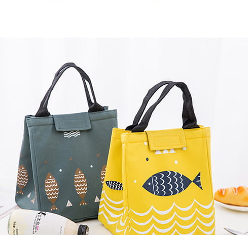 Mini cartoon oxford insulated picnic handbag in yellow with navy fish and white wave pattern featuring black handles.