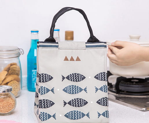 Mini cartoon oxford insulated picnic handbag in yellow with navy fish and white wave pattern featuring black handles.