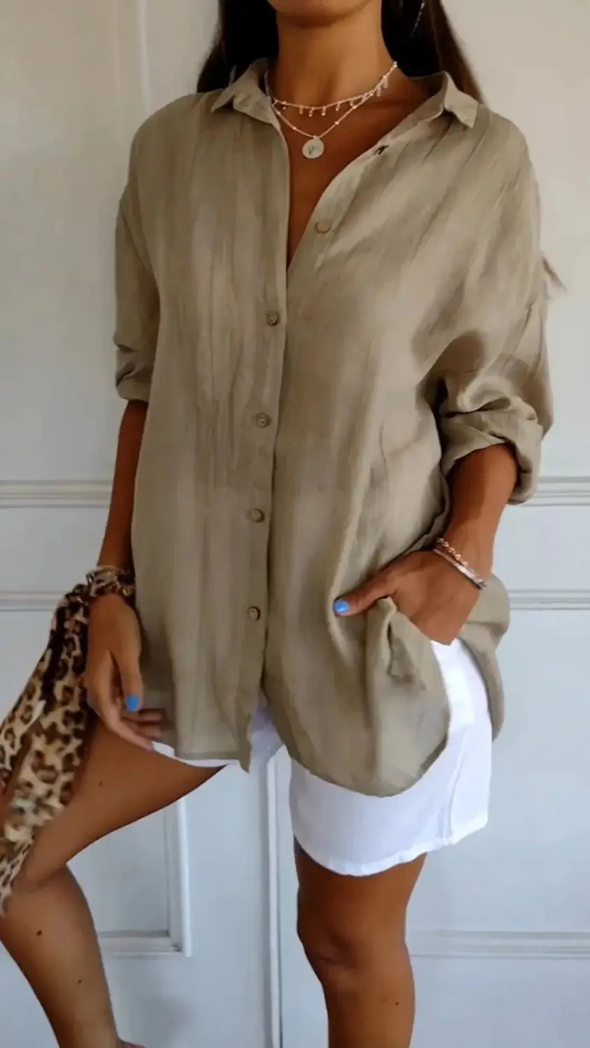Beige linen women’s relaxed pleated button up shirt with rolled sleeves and a relaxed fit.