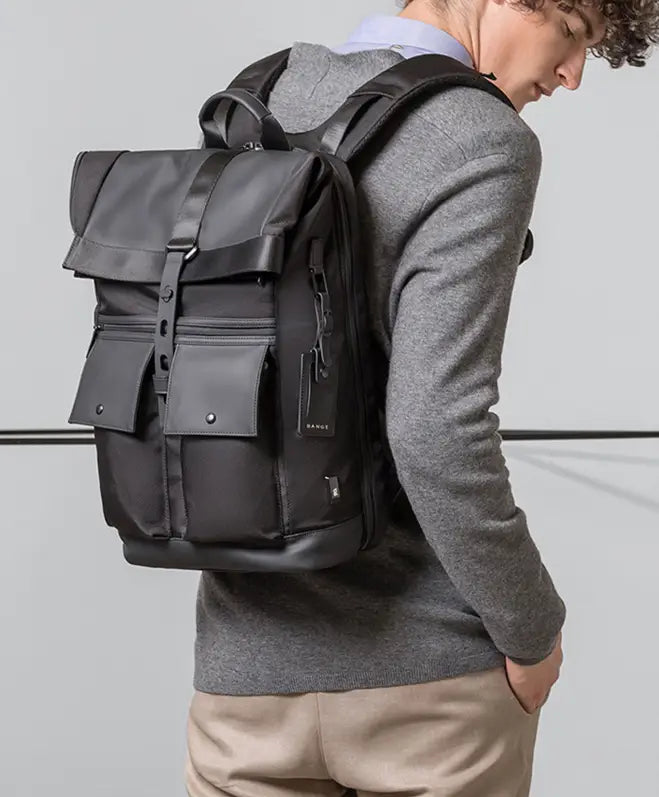 Men’s 16 inch roll top laptop backpack in black nylon with sleek modern design and durable fabric construction shown from the back.