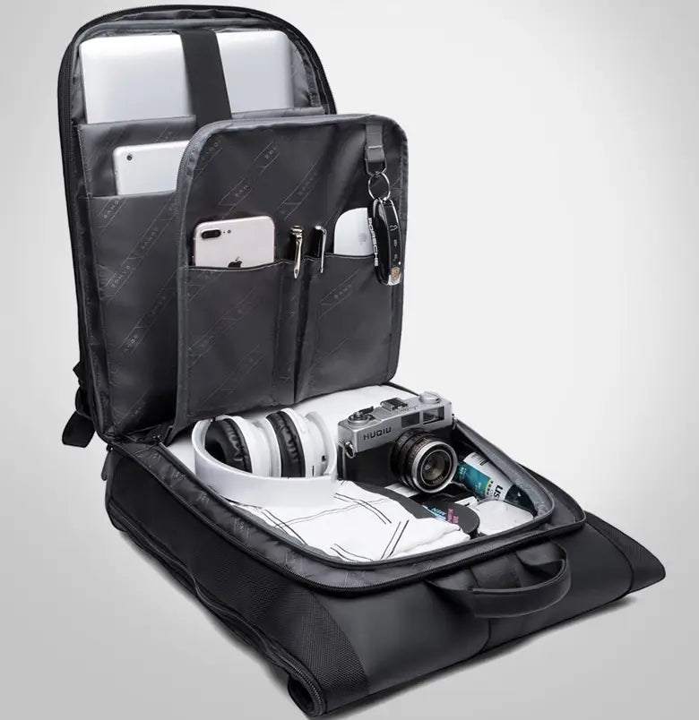 Men’s 16 inch roll top laptop backpack in black nylon featuring multiple compartments and padded sections for organizing electronics accessories and clothing.