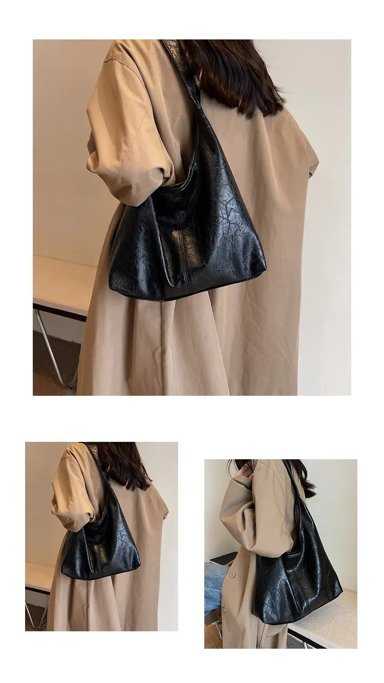 Vintage-Leder-Tragetasche mit großer Kapazität als Schulterhandtasche aus schwarzem, strukturiertem Leder mit einem dezenten Prägemuster und einem schlanken, minimalistischen Design.