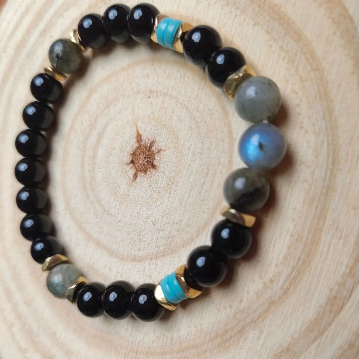 A natural amethyst and magnetic stone beaded unisex bracelet featuring alternating black obsidian gray labradorite with blue iridescence and turquoise beads separated by small gold-toned spacers.