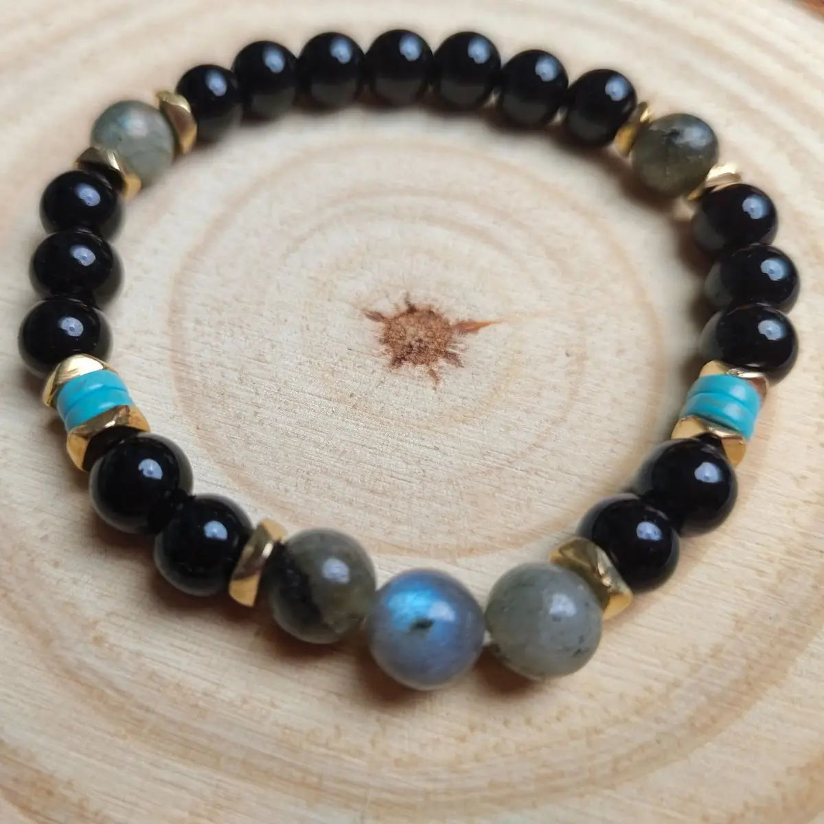 Natural amethyst and magnetic stone beaded unisex bracelet featuring black gray and turquoise beads with gold-toned spacers.
