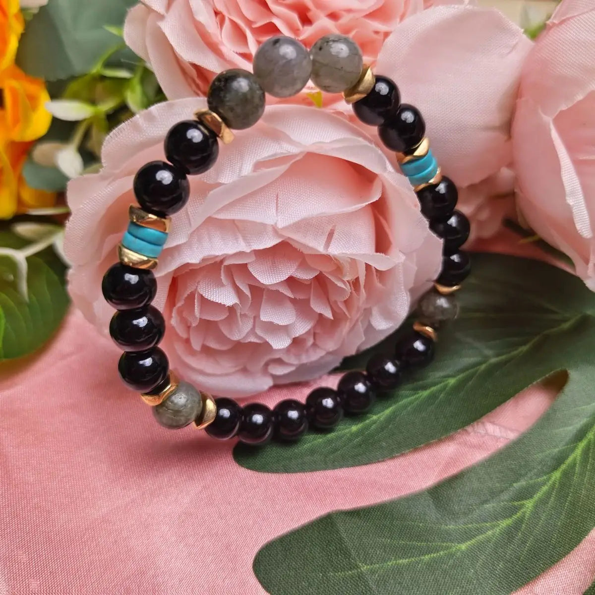 A stylish natural amethyst and magnetic stone beaded unisex bracelet featuring alternating black obsidian gray labradorite and turquoise stones separated by gold-toned metal spacers.