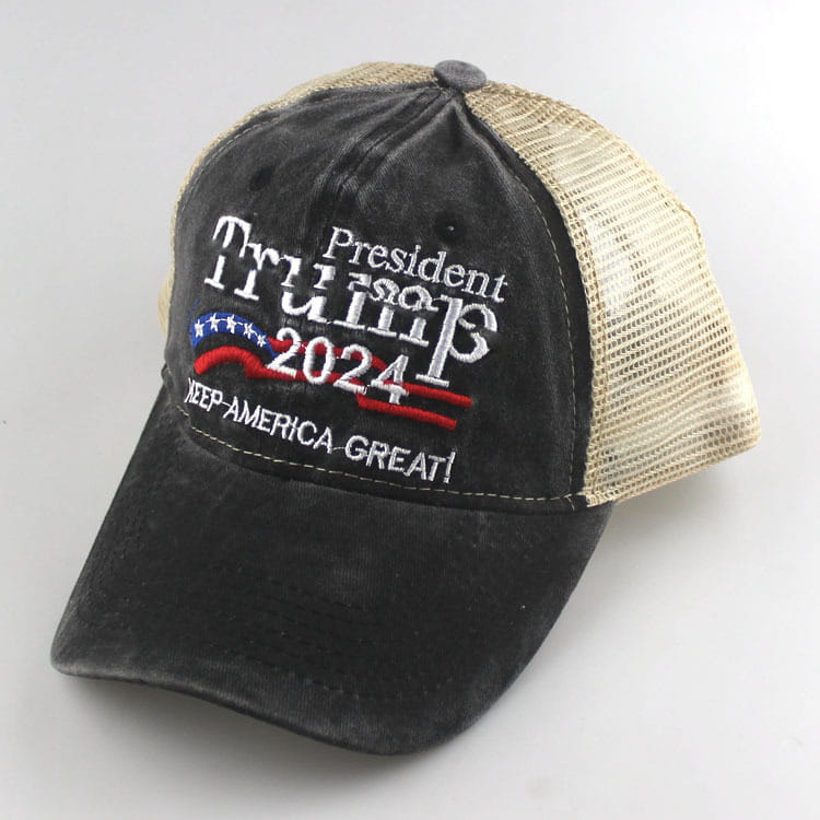 Black and beige trucker hat with embroidered president trump 2024 text, red white and blue patriotic design, and keep america great slogan, titled Trump 2024 embroidered trucker hat.