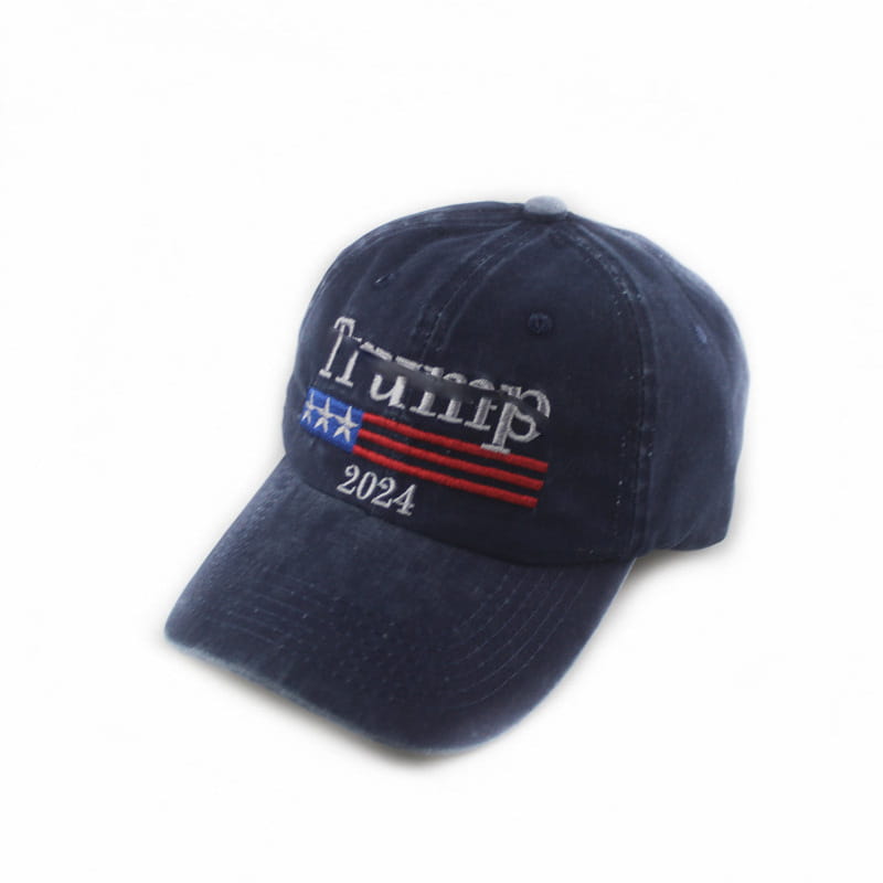Dark blue denim baseball cap with embroidered trump 2024 text and a stylized American flag design.