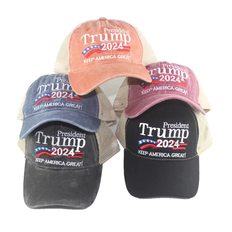 A collection of distressed trucker hats in faded orange navy blue and black with president Trump 2024 embroidered in white on the front.