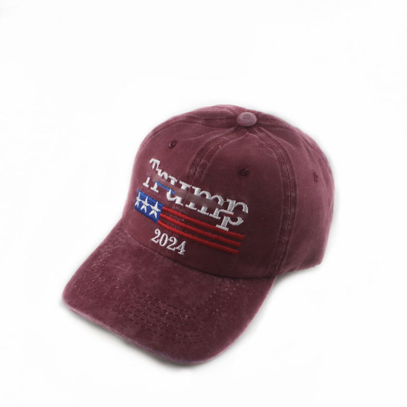 Maroon distressed cotton baseball cap with embroidered Trump 2024 text and American flag design for patriotic wear.