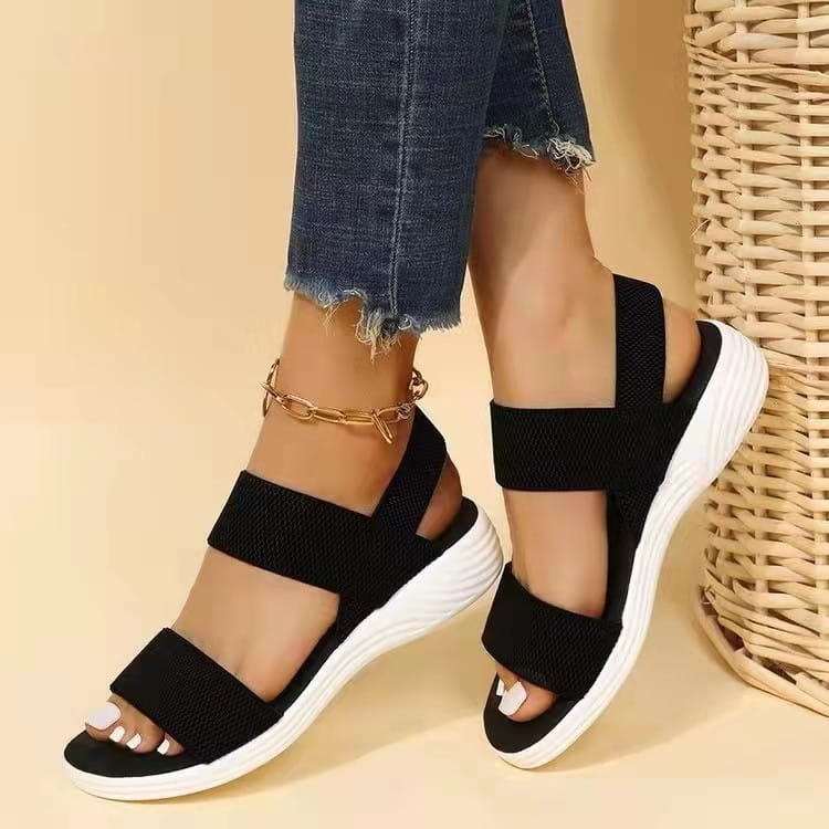 Flyknit elastic back strap flat sandals for women featuring black elastic straps and a white platform sole.