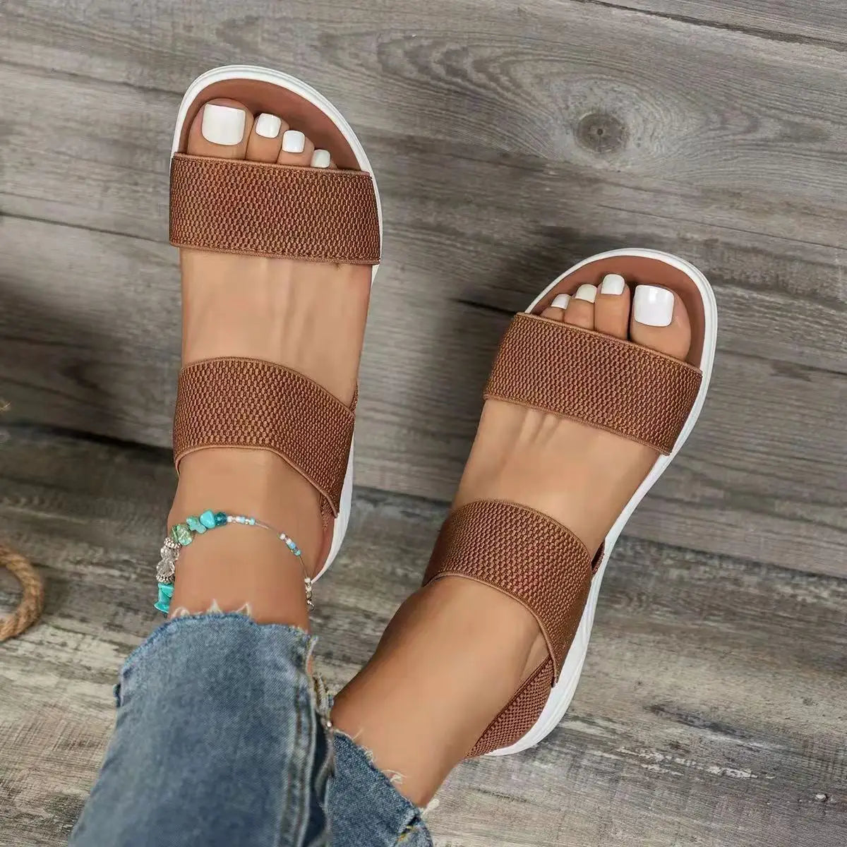 brown flyknit elastic back strap flat sandals for women featuring woven straps and a white rubber sole