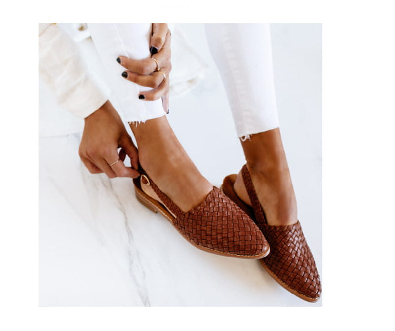 Brown woven leather pointed toe slingback flat mule sandals with a buckle detail.