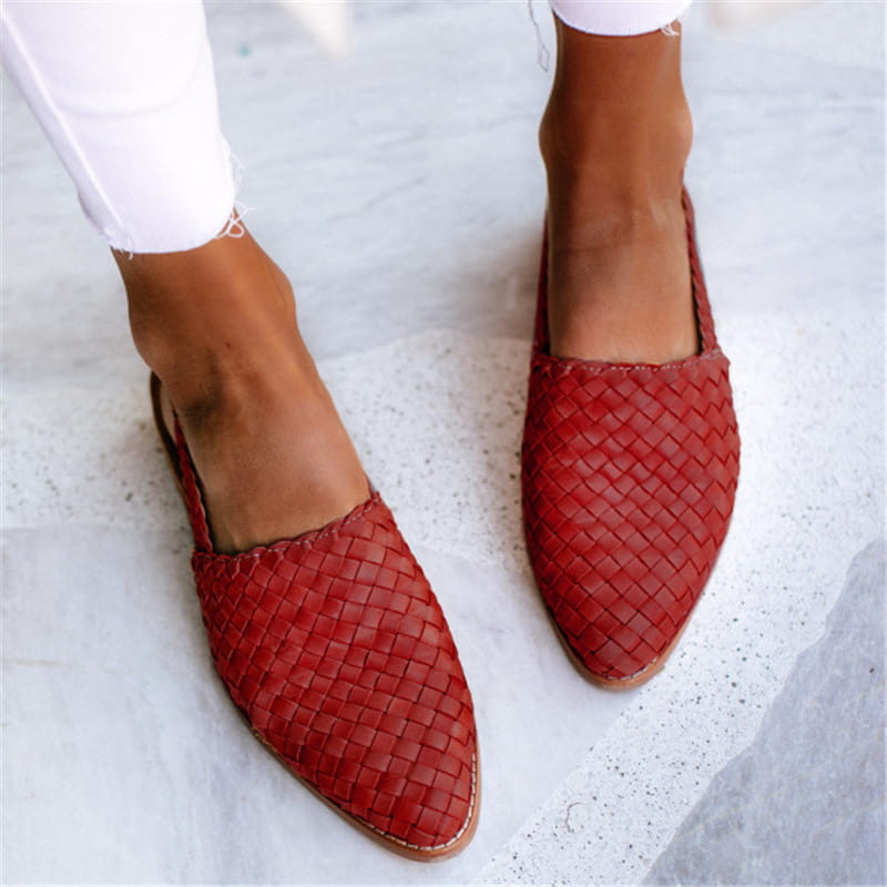 Red woven leather pointed toe buckle flat mule sandals with a light brown sole.