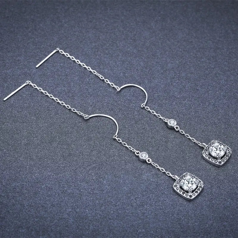 Silver plated zircon square drop earrings featuring a delicate silver chain, curved hook, and two tiers of black cubic zirconia set in elegant square halo designs.