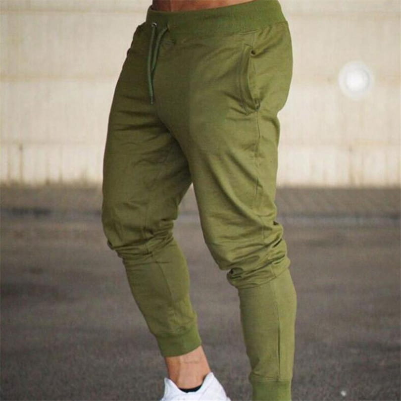 Men’s athletic training jogger pants in olive green featuring an elastic waistband with drawstring, tapered legs, and ribbed cuffs for a comfortable fit.