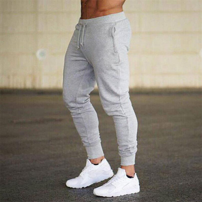 Men’s athletic training jogger pants in gray featuring a drawstring waistband and elastic cuffs made from comfortable sweatpant material.