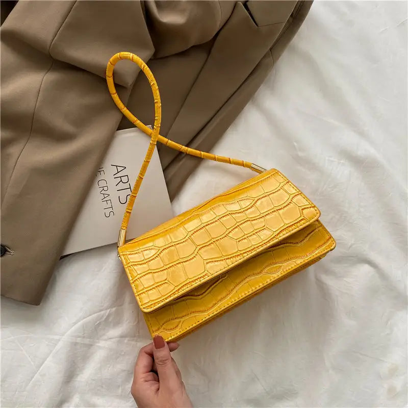 Vibrant yellow crocodile-embossed high-end PU clutch underarm bag with a matching woven strap.