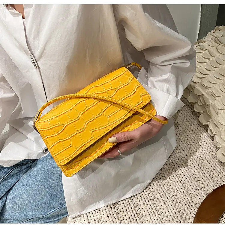 Vibrant yellow crocodile-embossed leather crossbody bag with matching adjustable strap and high-end PU clutch design.