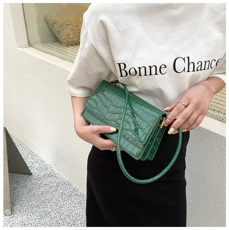 Emerald green croc-embossed mini crossbody bag made of high-end pu with a sleek, structured design and gold-tone hardware suitable as a clutch or underarm bag.