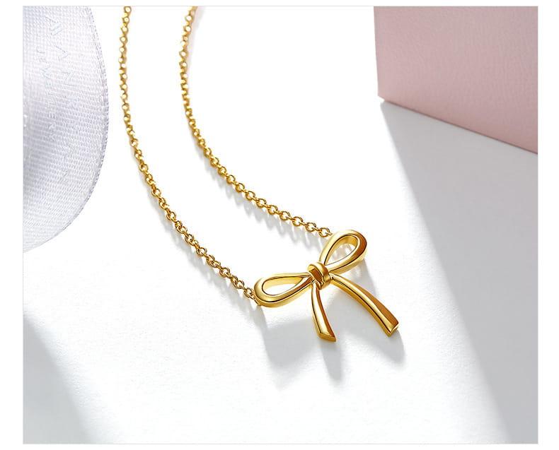 Gold-colored bow-shaped pendant necklace with a delicate chain in Korean style gold and silver clavicle necklace design.
