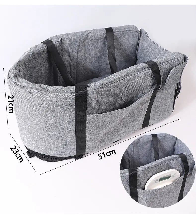 Grauer Stoff für Hundesitz im Auto und Transportbox für Haustiere mit schwarzen Riemen und einer Reißverschluss-Tasche.