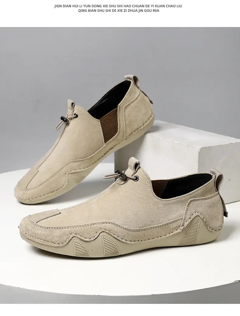 Beige breathable suede leather loafers with slip-on design brown mesh panel accents and textured wave-patterned sole for casual wear.