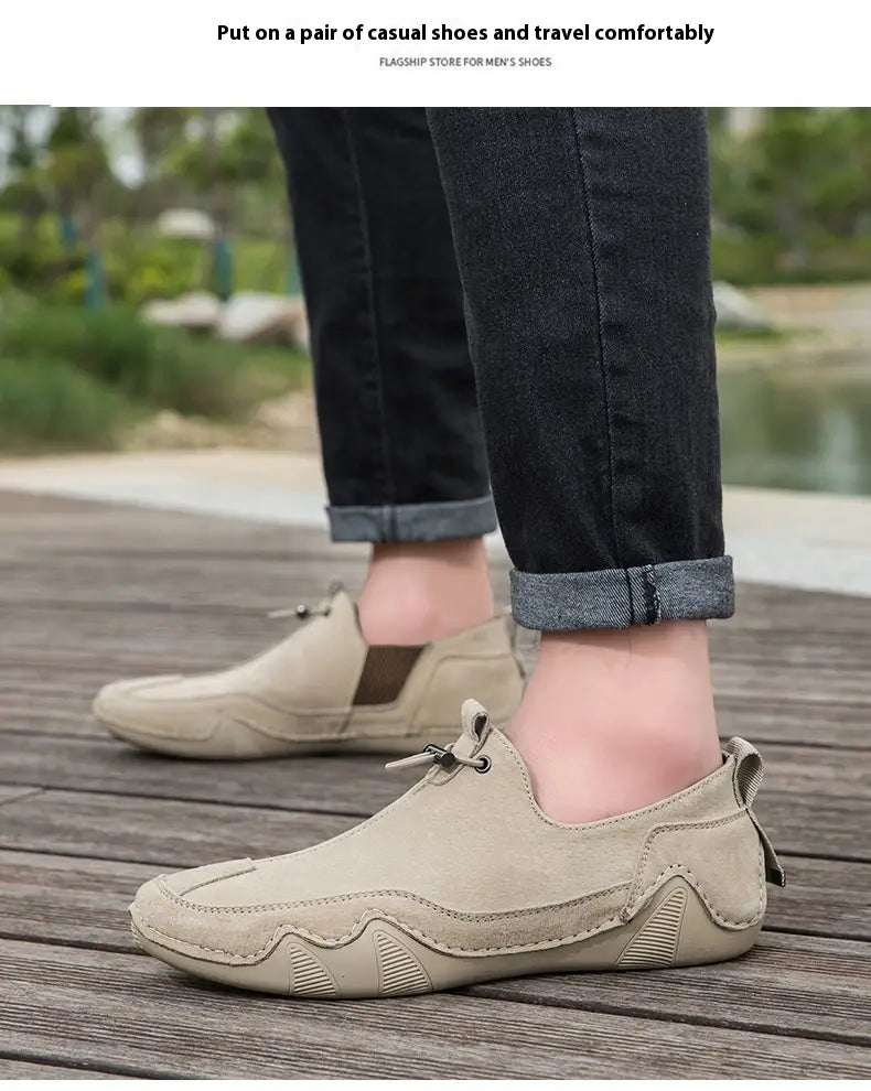 Beige suede leather loafers with breathable slip-on design textured rubber sole and side zipper detail for casual wear.