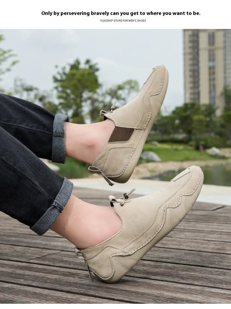 Beige suede slip-on leather loafers with a breathable textured mesh panel on the side and white laces for casual wear.
