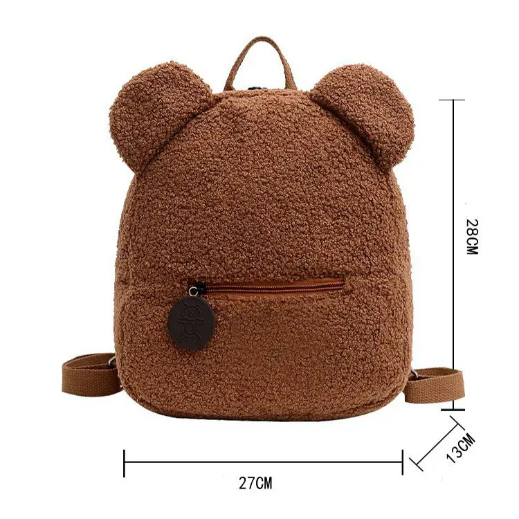A cozy brown teddy bear shaped plush backpack featuring a fuzzy fleece texture and soft rounded ears.