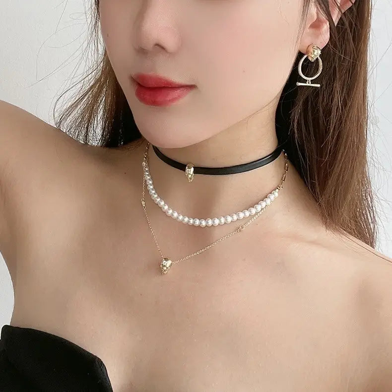 black leather choker necklace featuring a small gold skull pendant as part of the punk zirconium skull y-shaped pearl necklace set.