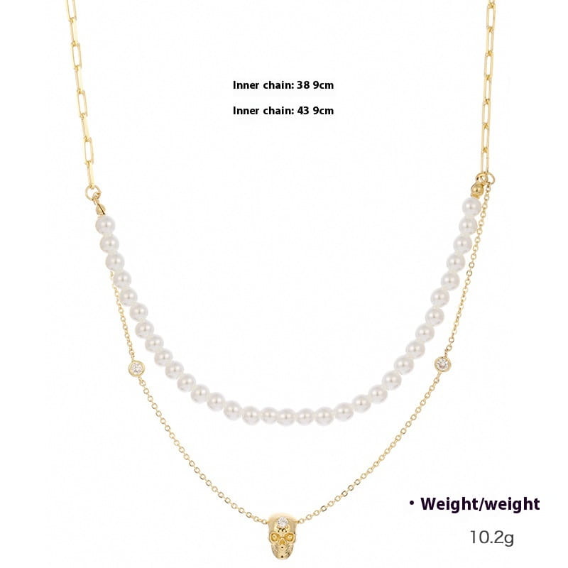 gold-toned skull pendant necklace with two layered chains featuring white pearls and small diamond accents from the punk zirconium skull y-shaped pearl necklace set.