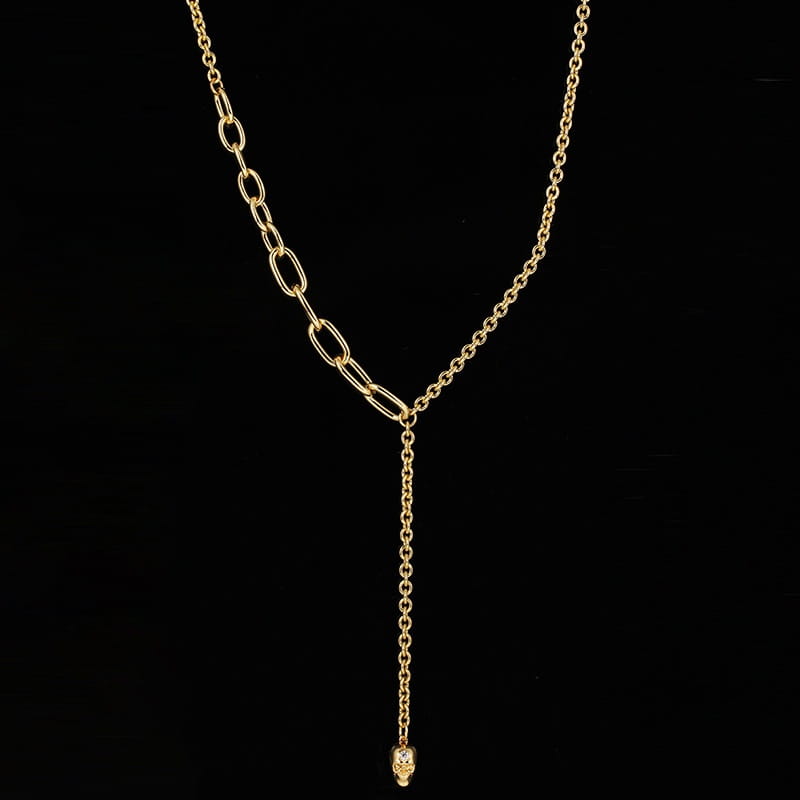 Gold-toned chain necklace with a y-shaped design featuring alternating oval and circular links and a small zirconium skull pendant in a punk style pearl necklace set.