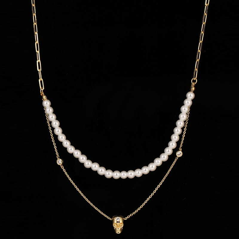 Gold-toned punk zirconium skull pendant necklace set with a double-layer design featuring white pearls and delicate chains.