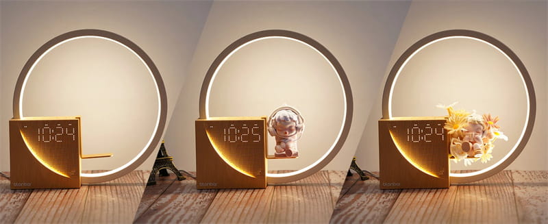 Gold-colored digital led bedside lamp with alarm clock and natural sounds featuring a sleek modern design and illuminated circular ring base.