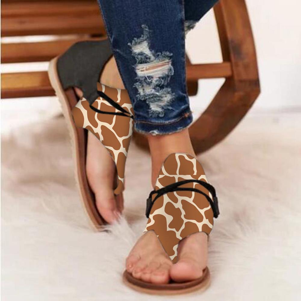 Women sandals animal print flat thong strappy shoes featuring brown and cream giraffe print thong sandals with black straps.