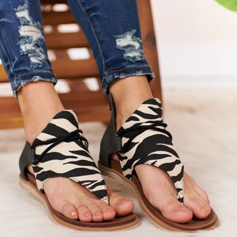 women sandals animal print flat thong strappy shoes featuring black and white zebra-print straps with a flat brown sole