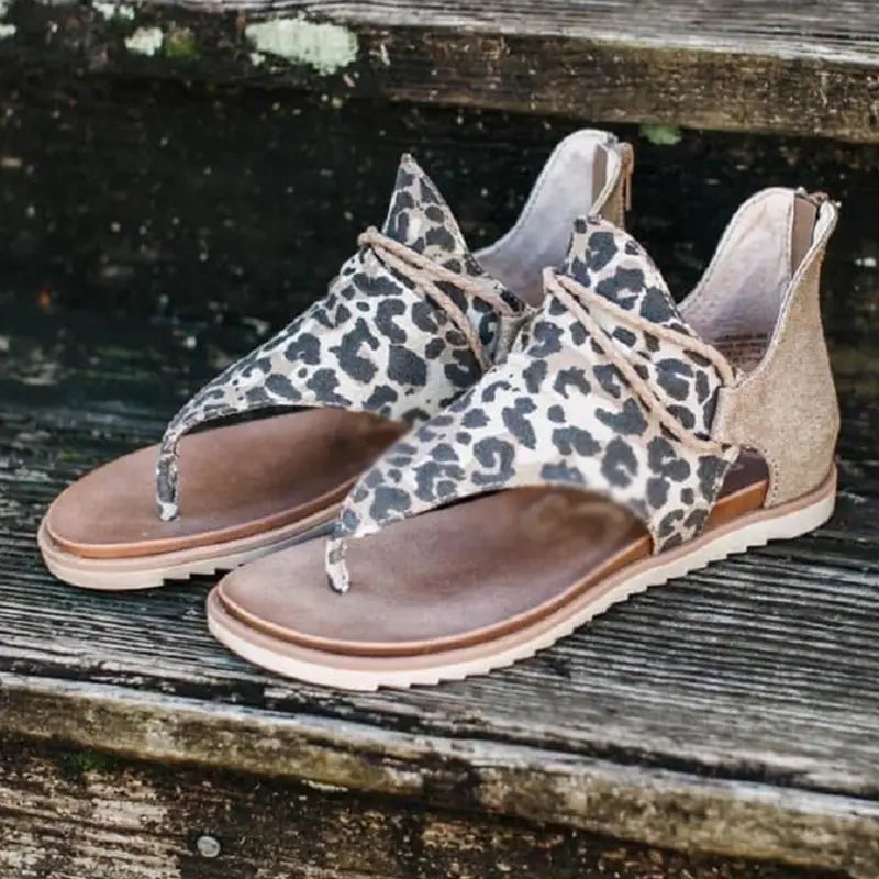 Women sandals animal print flat thong strappy shoes featuring leopard-print thong sandals with tan laces and a suede-like finish.