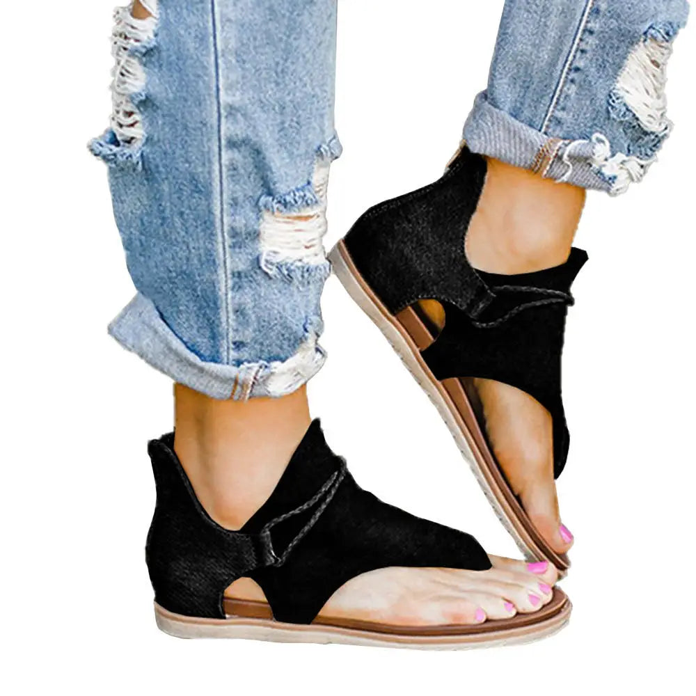 black suede-like women sandals with animal print flat brown sole and adjustable ankle straps shown from the back side