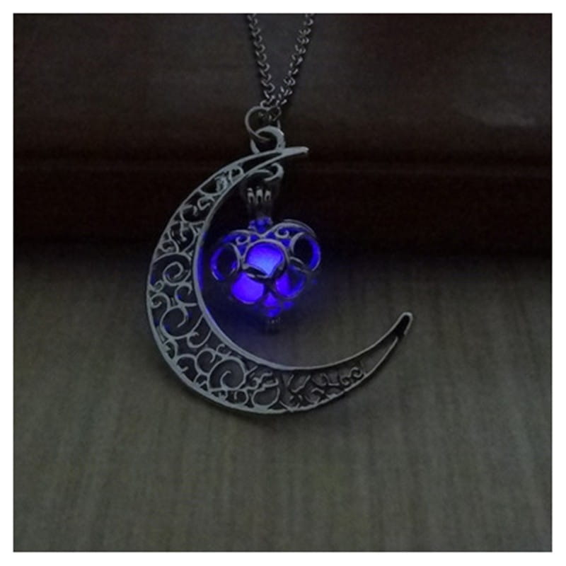 silver crescent moon pendant necklace with intricate filigree design and glowing blue heart shaped led light inside titled luminous heart and filigree crescent moon pendant necklace