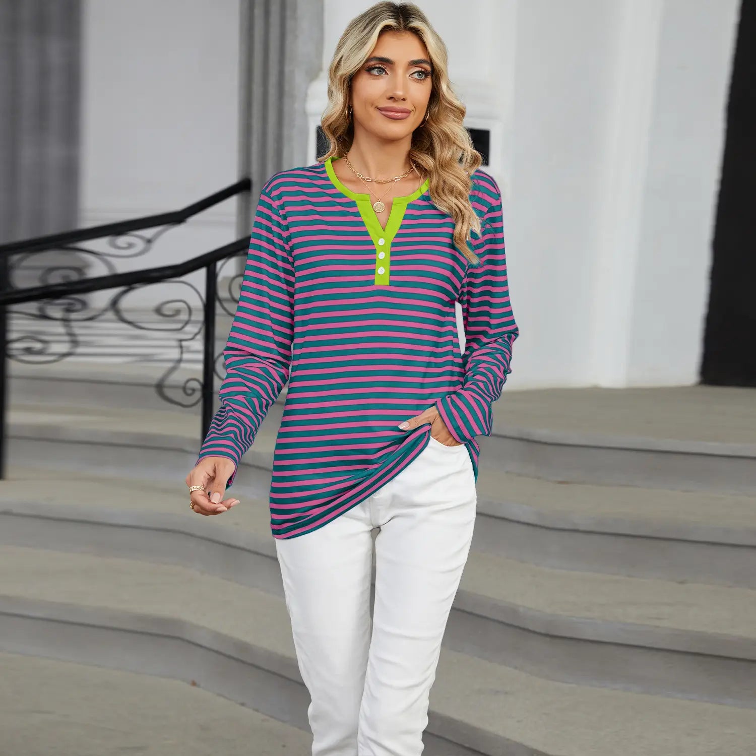 A long-sleeved striped henley long sleeve v neck t shirt in purple and teal with a vibrant lime green collar and placket.