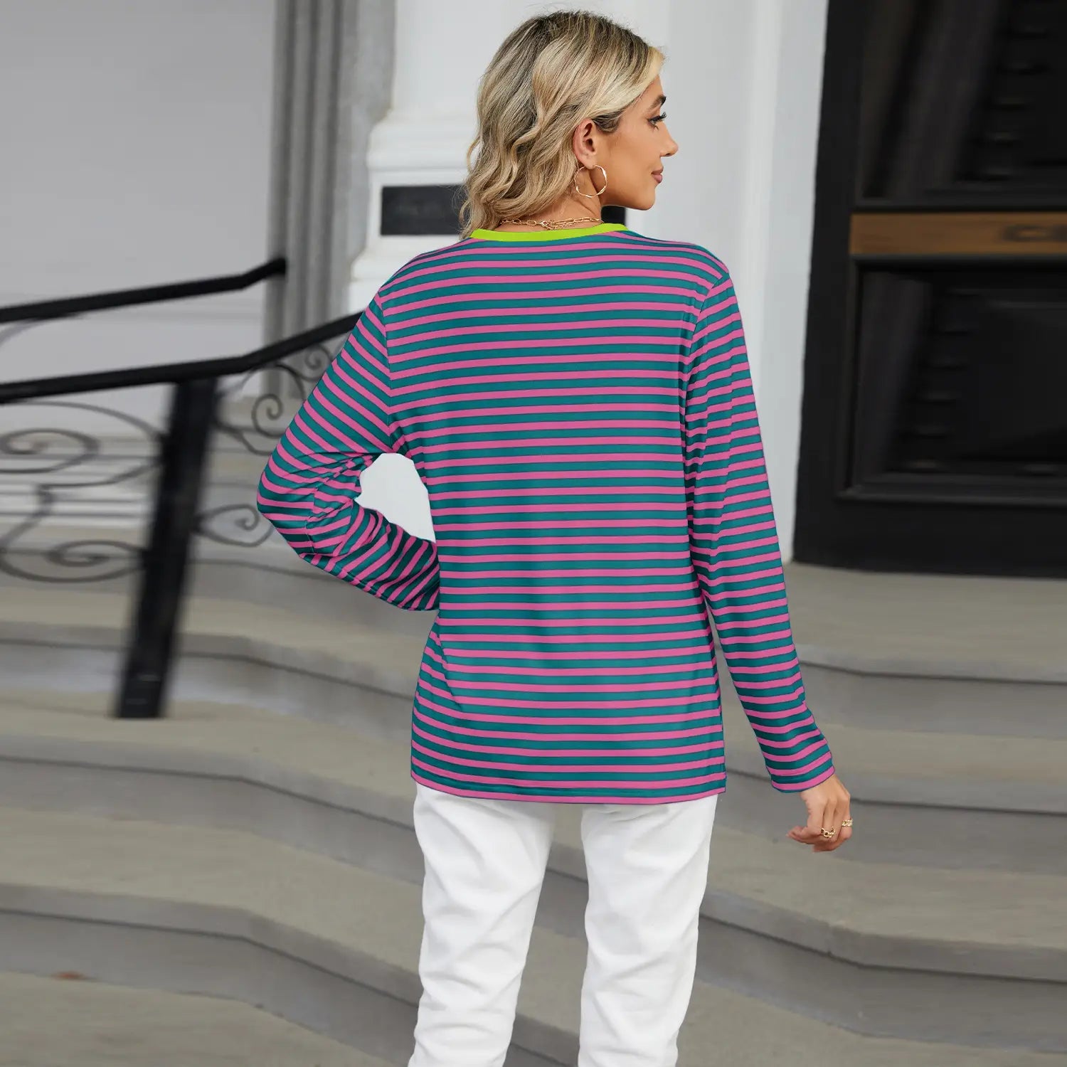 A long-sleeved striped contrast henley top with horizontal purple and teal stripes and a lime green trim round neckline.
