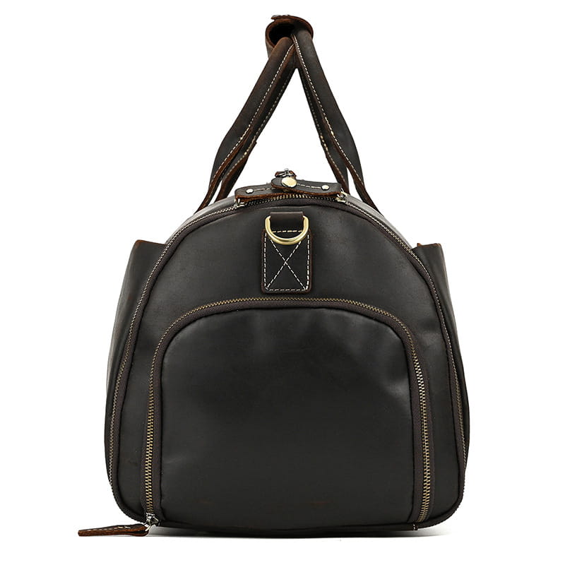 Black leather duffel bag with brown stitching and gold tone hardware designed as a vintage large folding travel bag.