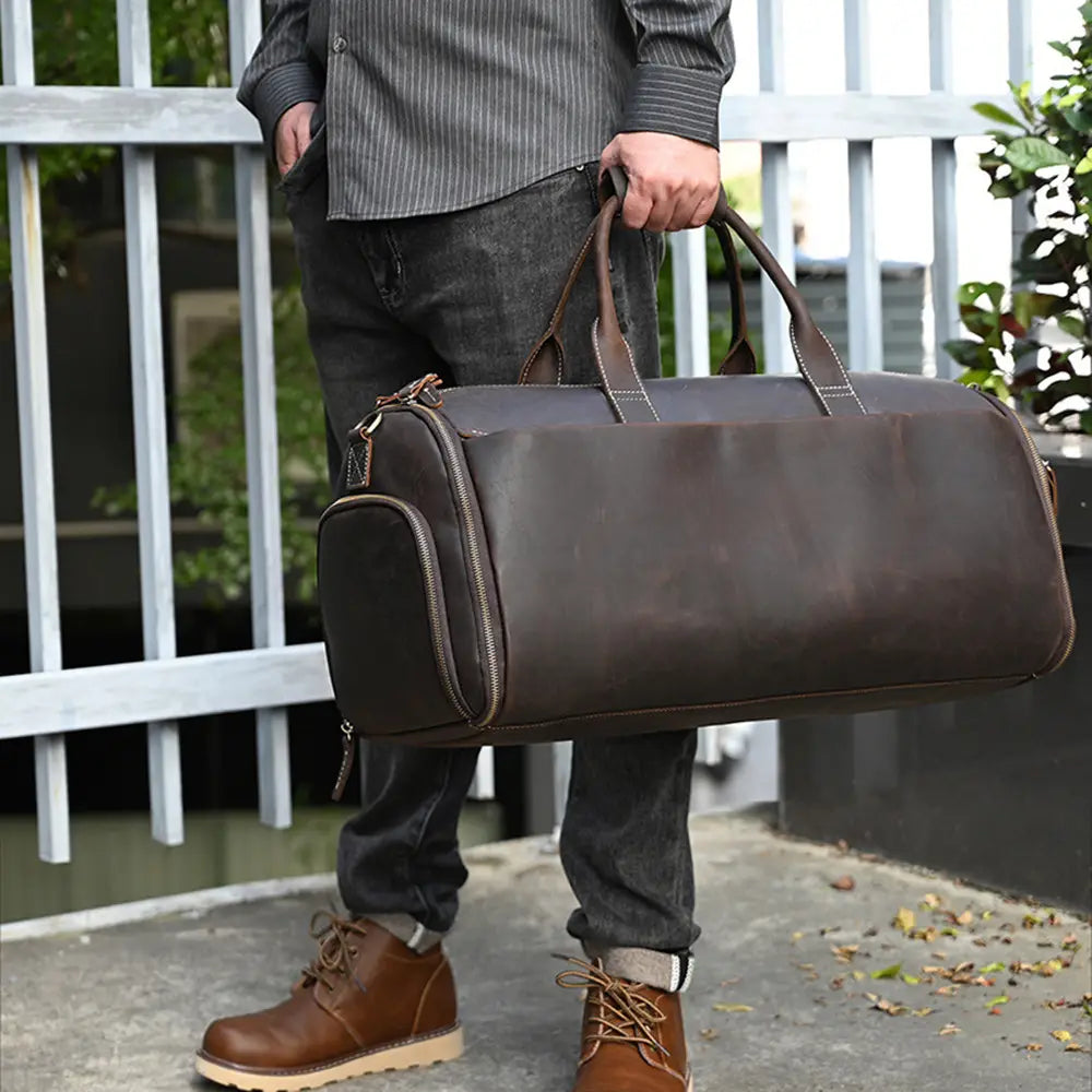 brown leather duffel bag with sturdy handles and a front zippered pocket vintage large folding travel bag